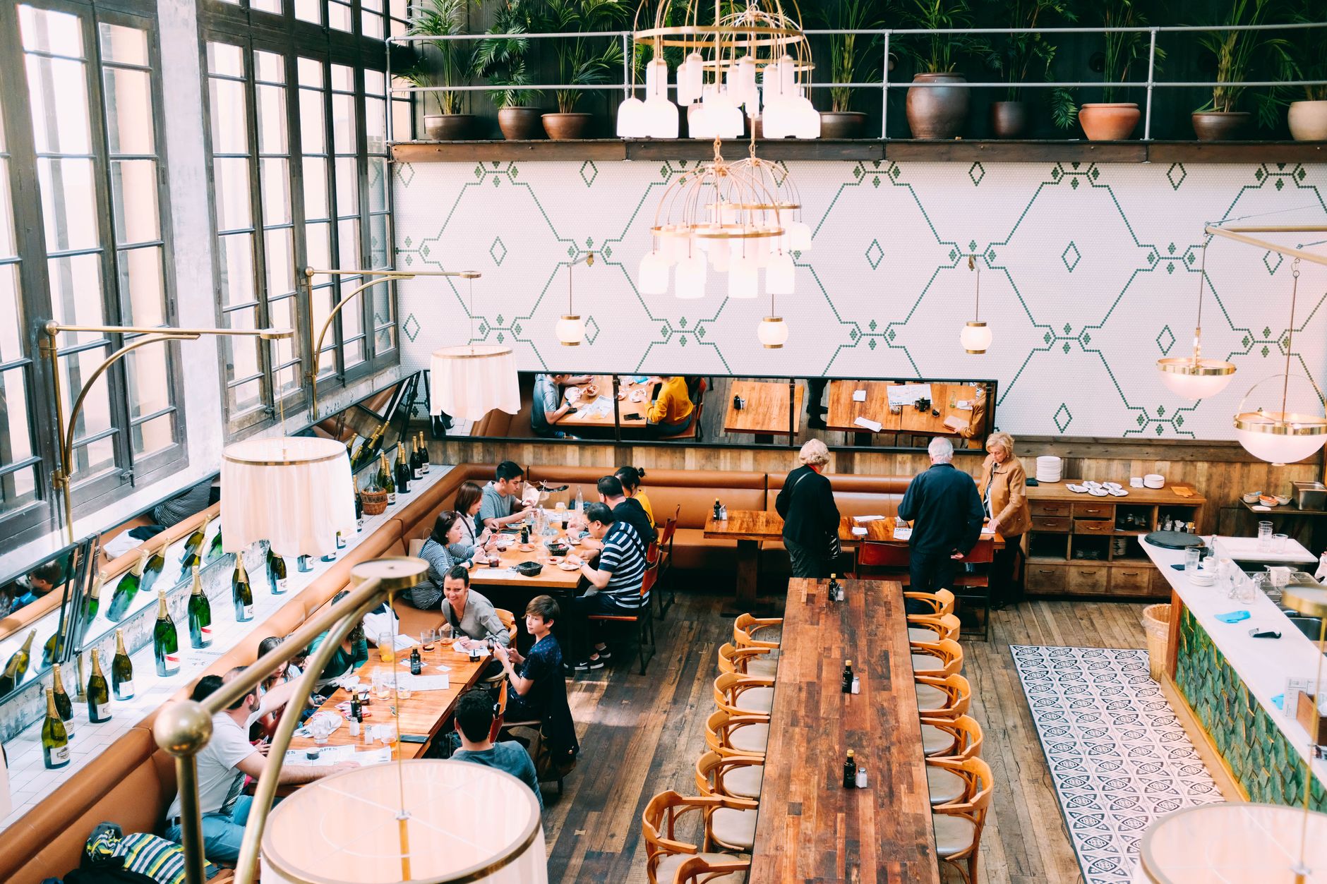 A busy restaurant dining room with tables set for service