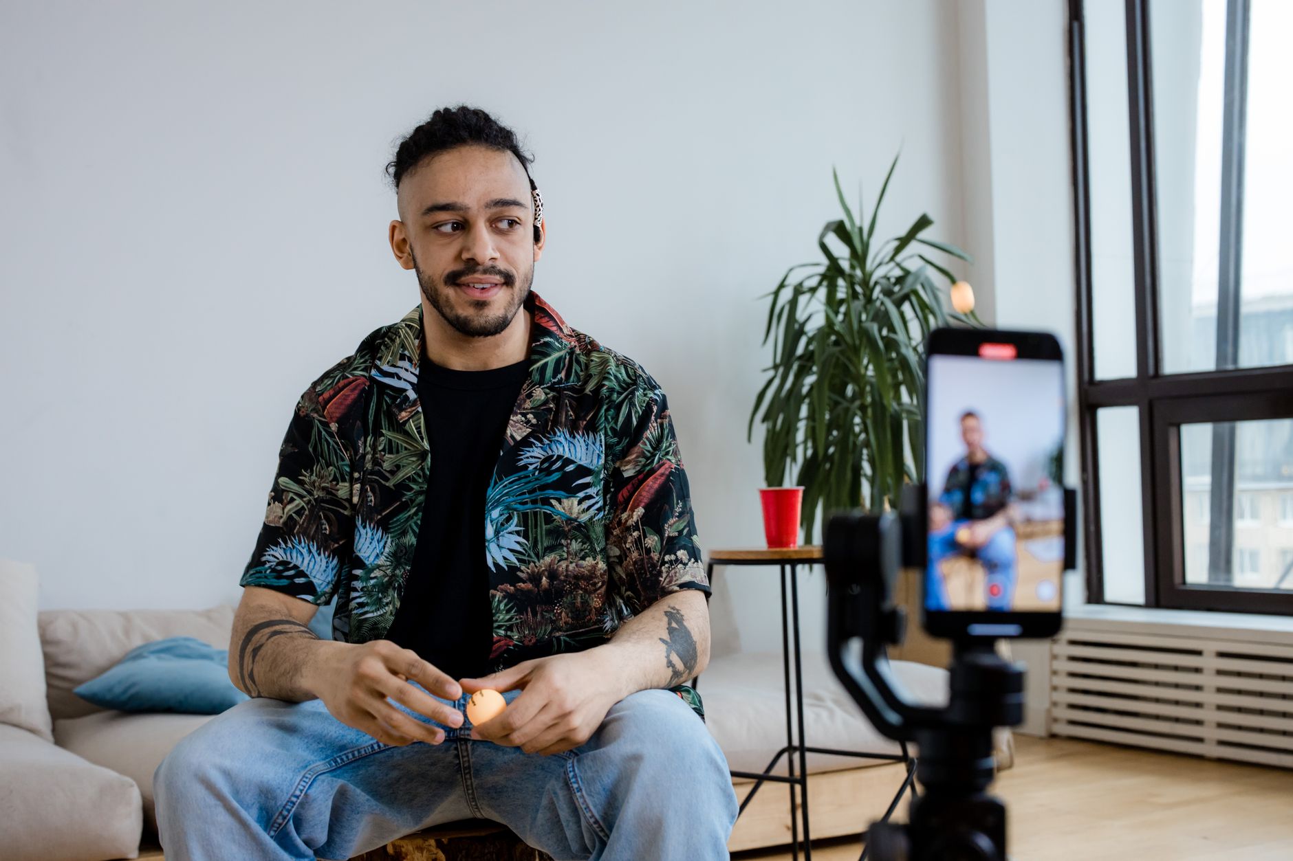 A creator filming a product video with a phone on a tripod