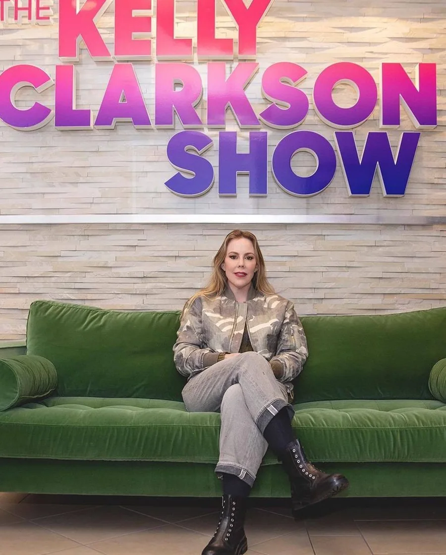 Candice seated on the green couch on the Kelly Clarkson Show set