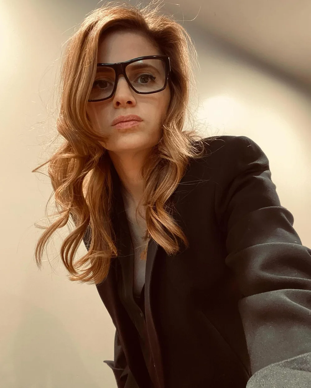 Stana Katic wearing a Gucci suit and glasses
