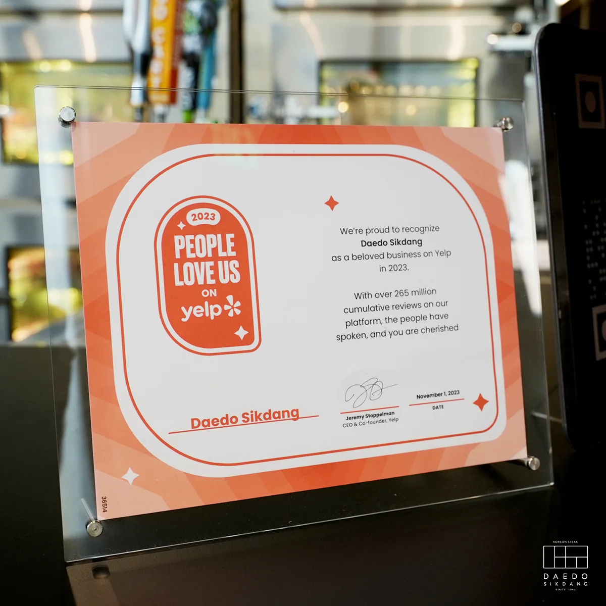The People Love Us On Yelp recognition framed at the Daedo Sikdang host stand