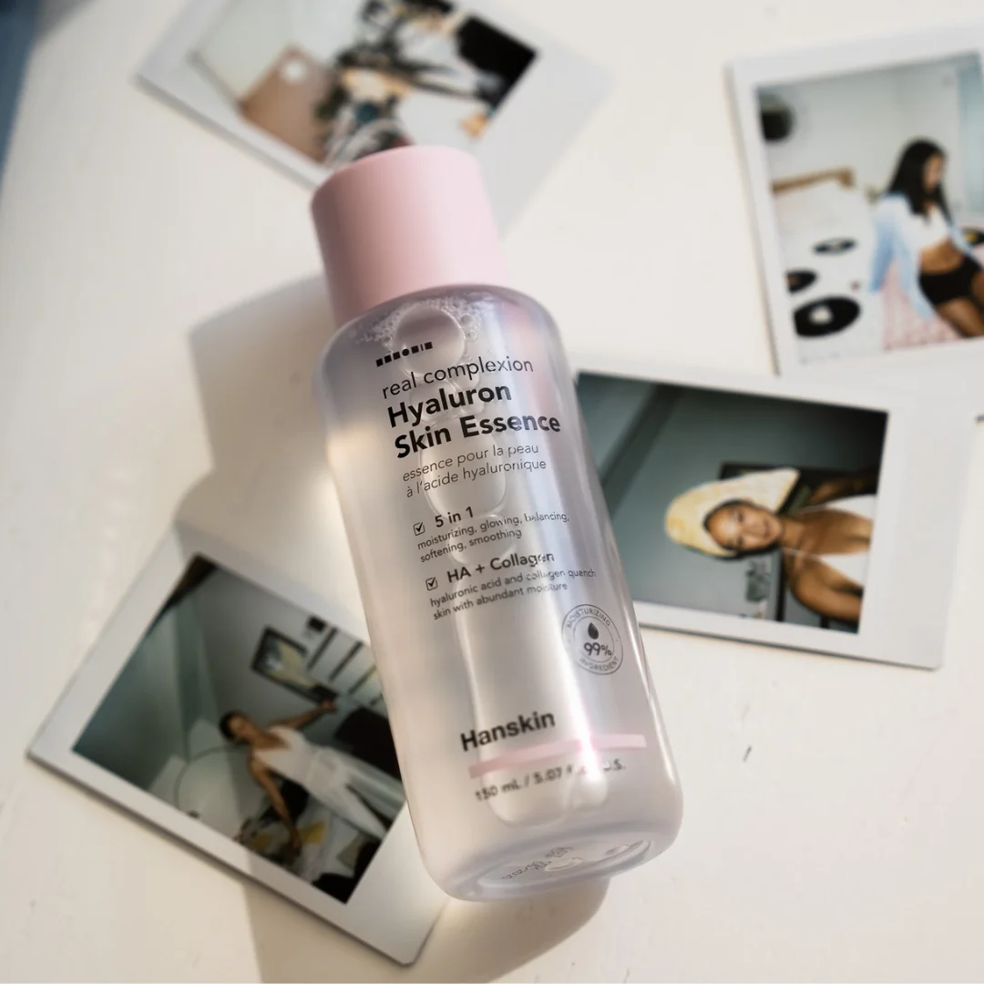 Hanskin Hyaluron Skin Essence bottle laid over summer polaroids