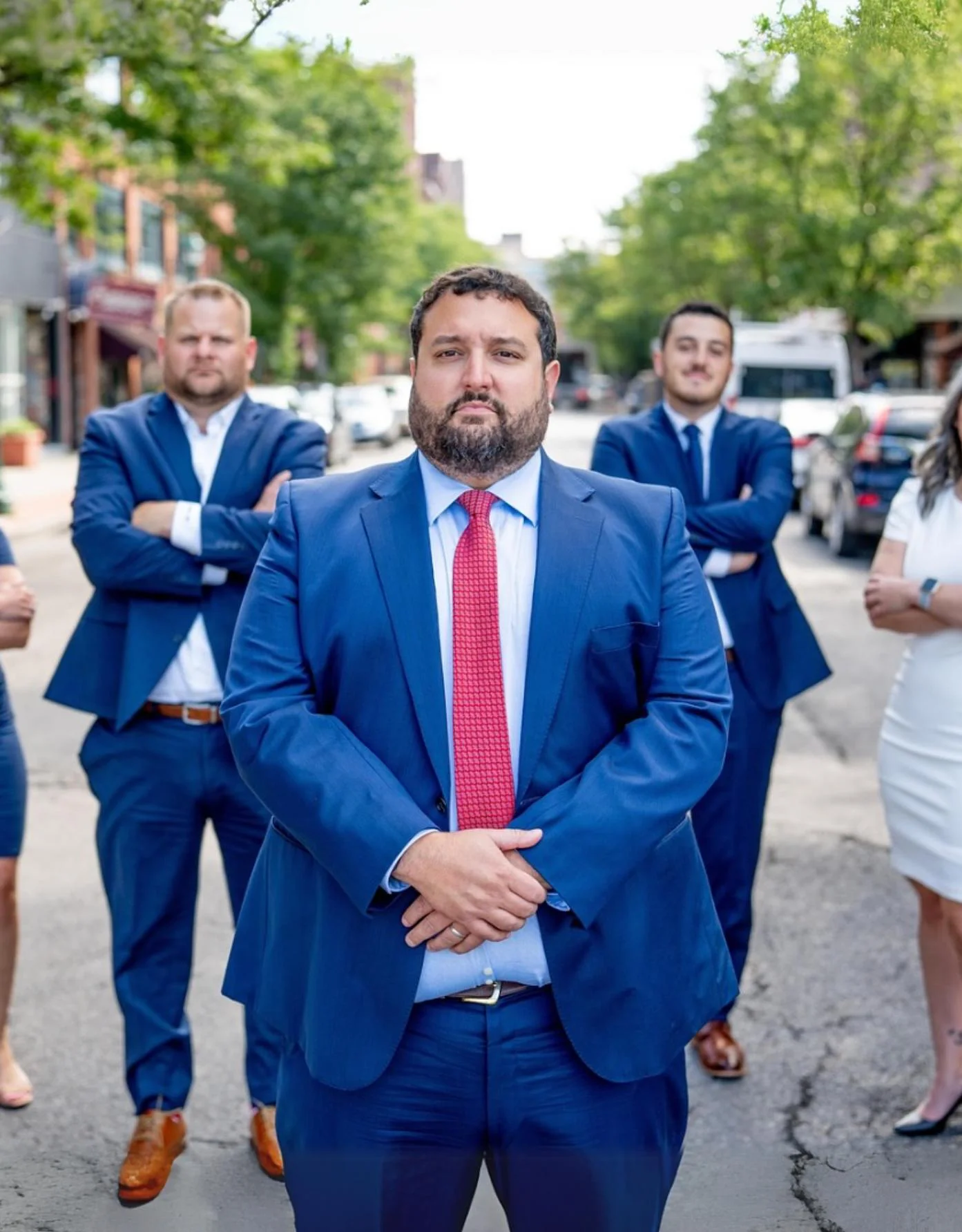 The Nave Law Firm team standing in a Syracuse street, the founder front and center