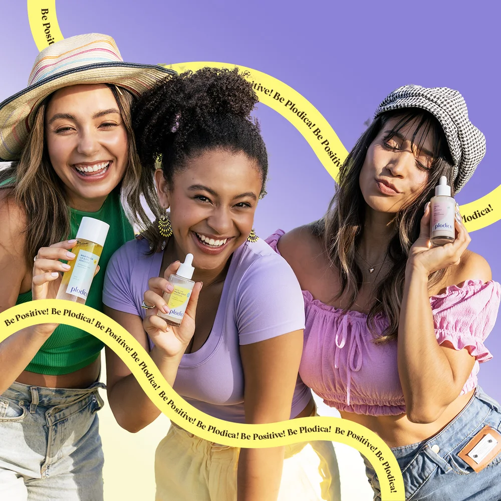 Three women laughing together holding Plodica products